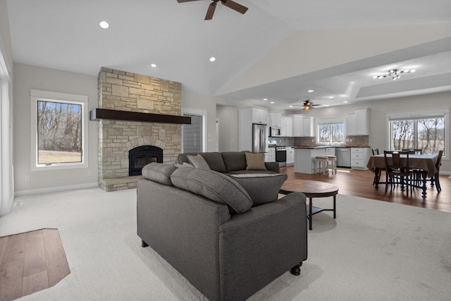 W4668 Reetz Rd, Princeton, WI 54968 - living room featuring ceiling fan, light colored carpet, a fireplace, recessed lighting, and vaulted ceiling