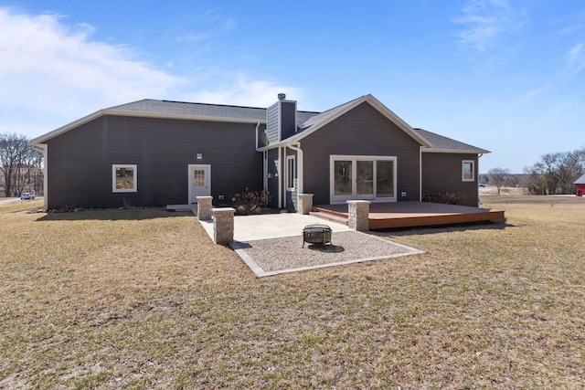 W4668 Reetz Rd, Princeton, WI 54968 - rear view of property with a fire pit, a deck, a yard, a chimney, and a patio area