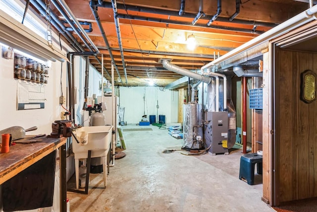 W3736 Oak St, Montello, WI 53949 - unfinished below grade area with heating unit, water heater, and a sink