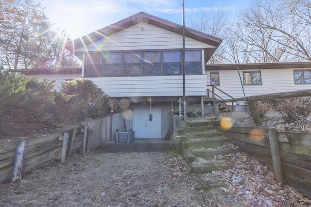 W3736 Oak St, Montello, WI 53949 - back of property featuring a sunroom, fence, and stairs