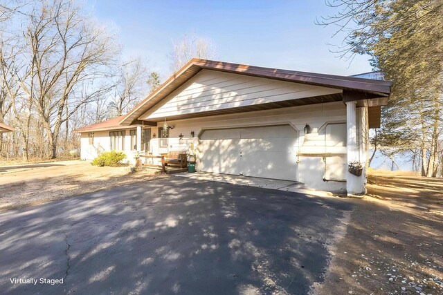 W3736 Oak St, Montello, WI 53949 - view of front of home featuring a garage and aphalt driveway