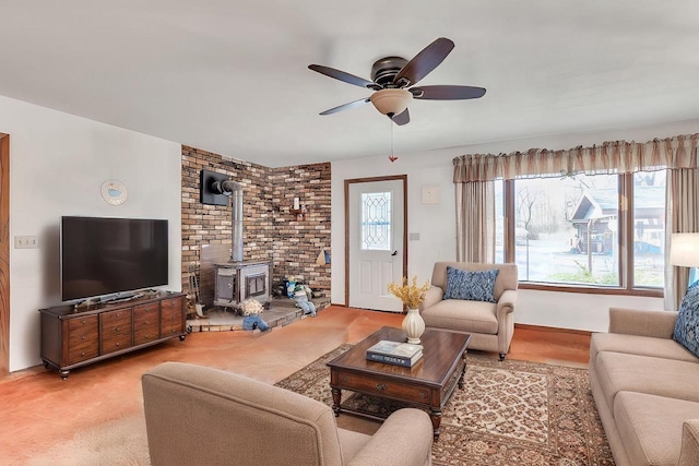 W3736 Oak St, Montello, WI 53949 - living room with ceiling fan, a wood stove, and carpet