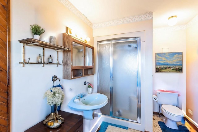 W3736 Oak St, Montello, WI 53949 - bathroom featuring a sink, toilet, a stall shower, and crown molding