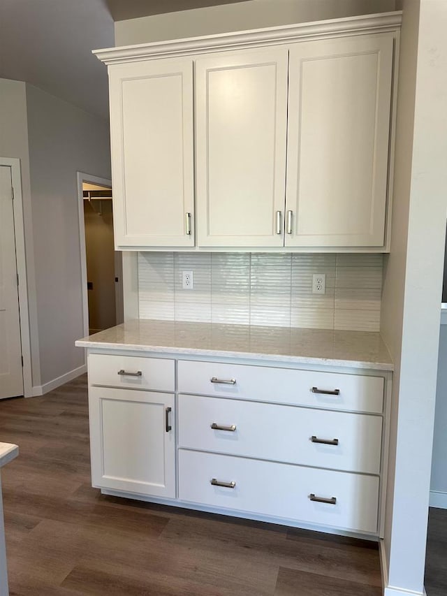 N9249 Constellation Dr, Appleton, WI 54915 - kitchen with tasteful backsplash, dark wood finished floors, white cabinetry, and light stone counters
