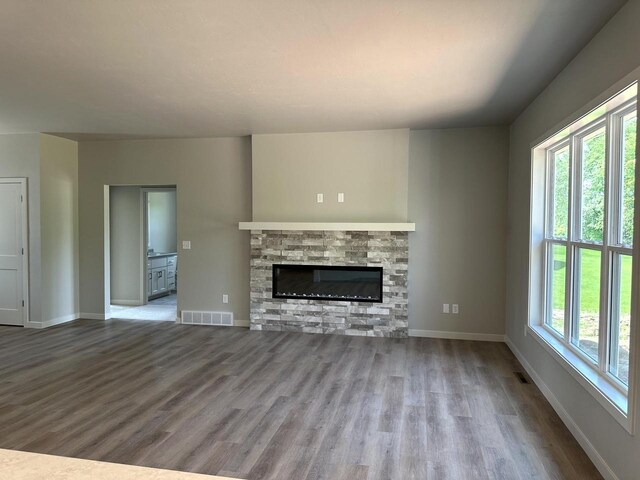 N9249 Constellation Dr, Appleton, WI 54915 - unfurnished living room featuring wood finished floors and a fireplace