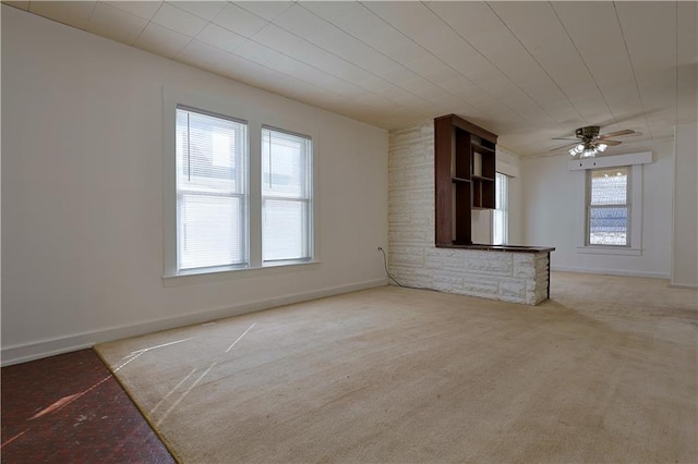 empty room with carpet, baseboards, and ceiling fan