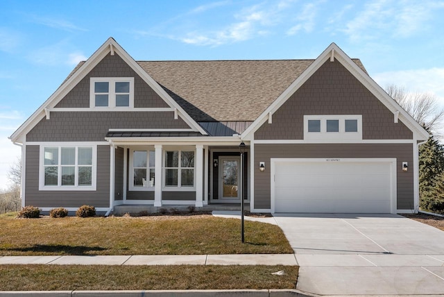 view of front of property with driveway, a front lawn, roof with shingles, and an attached garage