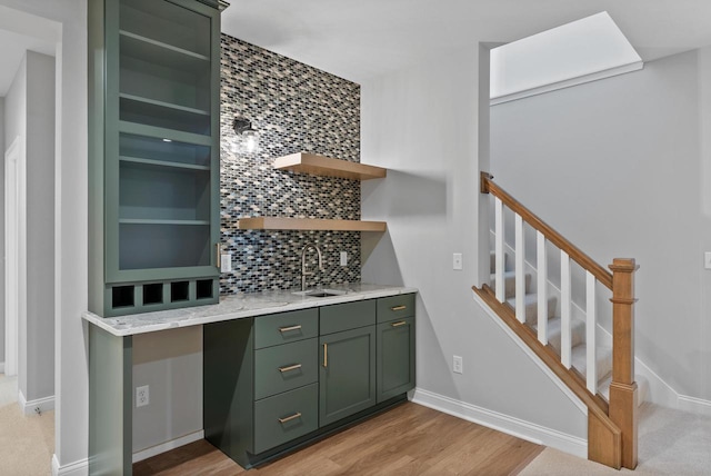W214N4987 Casey Ct, Menomonee Falls, WI 53051 - indoor wet bar with decorative backsplash, stairway, and light wood-style flooring