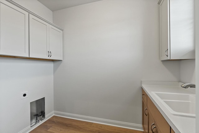 W214N4987 Casey Ct, Menomonee Falls, WI 53051 - laundry area with wood finished floors, electric dryer hookup, and cabinet space