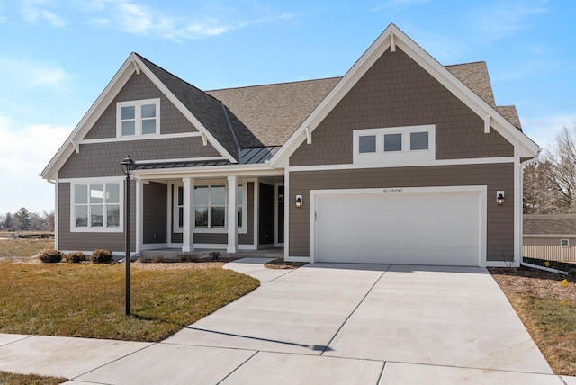 W214N4987 Casey Ct, Menomonee Falls, WI 53051 - view of front of house featuring a porch, driveway, a front yard, a garage, and a standing seam roof