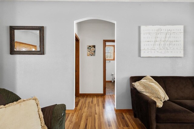 8464 County Rd S, Pulaski, WI 54162 - sitting room with arched walkways, baseboards, and wood finished floors