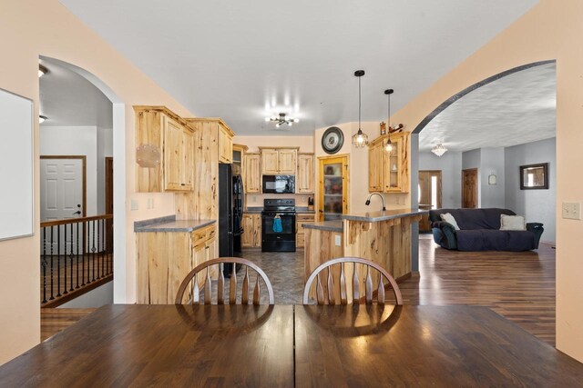 8464 County Rd S, Pulaski, WI 54162 - kitchen featuring dark countertops, arched walkways, light brown cabinets, open floor plan, and black appliances