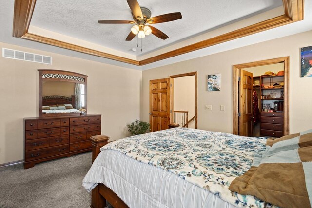 8464 County Rd S, Pulaski, WI 54162 - carpeted bedroom with a tray ceiling, a closet, a ceiling fan, a textured ceiling, and visible vents