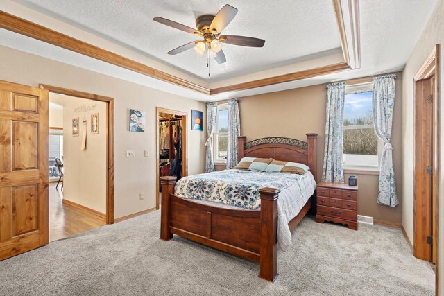 8464 County Rd S, Pulaski, WI 54162 - carpeted bedroom with a tray ceiling, baseboards, a textured ceiling, ceiling fan, and a closet