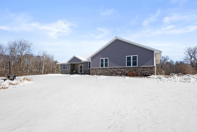 8464 County Rd S, Pulaski, WI 54162 - view of snowy exterior featuring stone siding