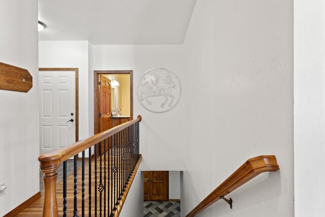 8464 County Rd S, Pulaski, WI 54162 - stairs with baseboards and wood finished floors