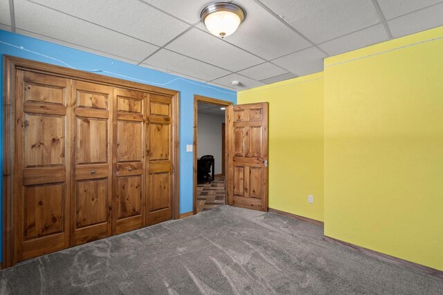 8464 County Rd S, Pulaski, WI 54162 - unfurnished bedroom featuring baseboards, carpet, and a drop ceiling