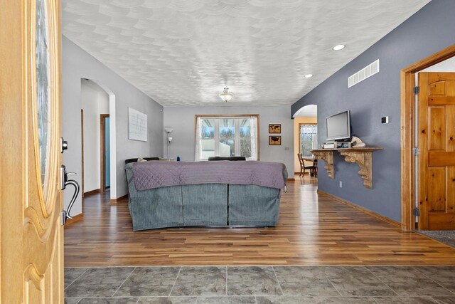 8464 County Rd S, Pulaski, WI 54162 - living room featuring visible vents, wood finished floors, and arched walkways