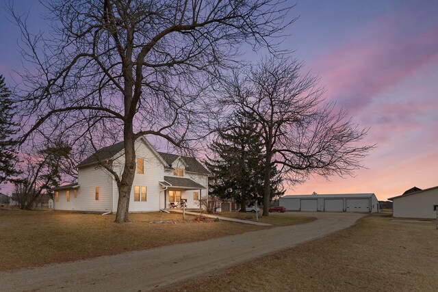 N402 24th Ave, Neshkoro, WI 54960 - view of front of home featuring driveway, an outdoor structure, and a garage