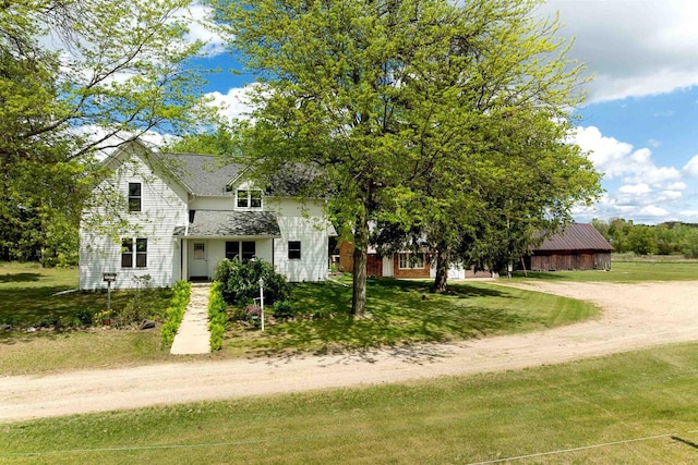 N402 24th Ave, Neshkoro, WI 54960 - obstructed view of property featuring a front yard, driveway, and roof with shingles