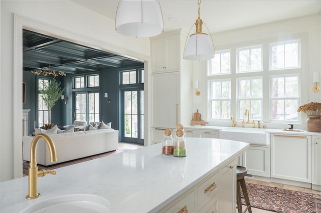 545 Wisconsin Ave, Delafield, WI 53018 - kitchen with coffered ceiling, beamed ceiling, light stone counters, and a sink