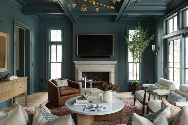 545 Wisconsin Ave, Delafield, WI 53018 - living area featuring coffered ceiling, beam ceiling, a notable chandelier, a fireplace, and wood finished floors