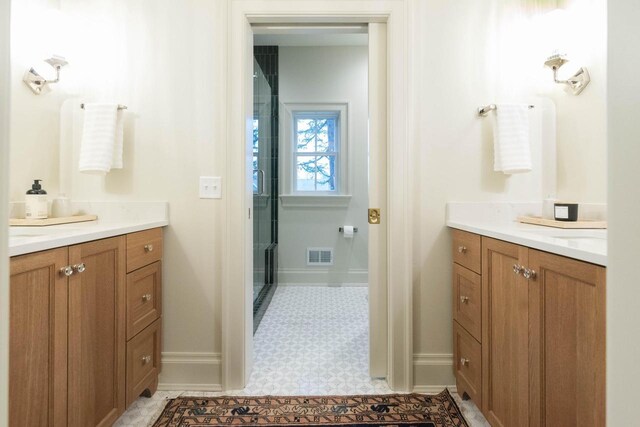 545 Wisconsin Ave, Delafield, WI 53018 - bathroom with vanity, a stall shower, baseboards, and visible vents
