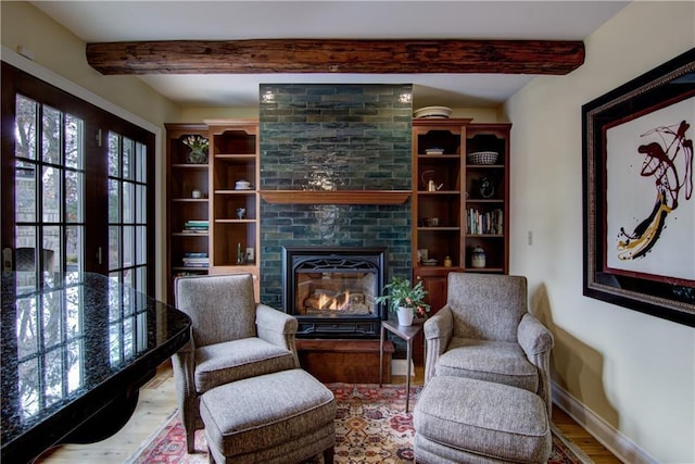 3736 Forest Knoll Dr, Eau Claire, WI 54701 - sitting room featuring baseboards, beamed ceiling, wood finished floors, and a fireplace