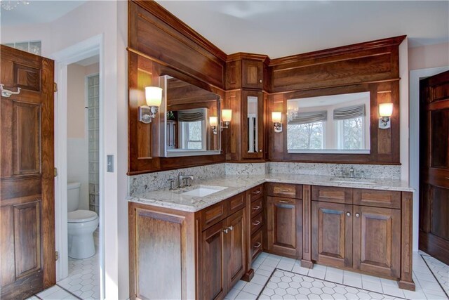 3736 Forest Knoll Dr, Eau Claire, WI 54701 - full bathroom featuring double vanity, toilet, a sink, and tile patterned floors