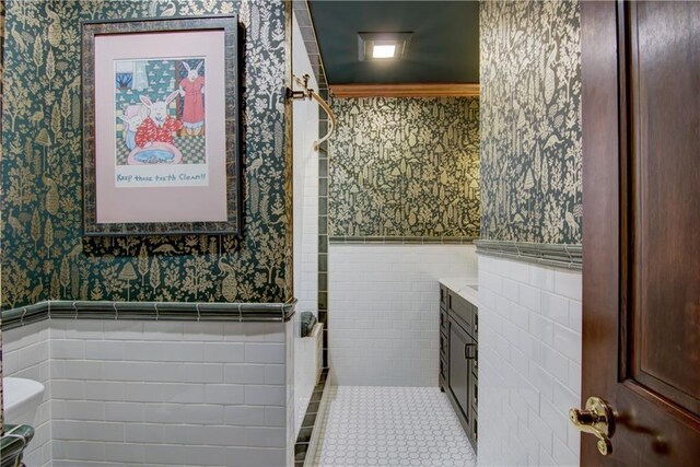 3736 Forest Knoll Dr, Eau Claire, WI 54701 - full bath featuring tile walls, wallpapered walls, tile patterned floors, and wainscoting