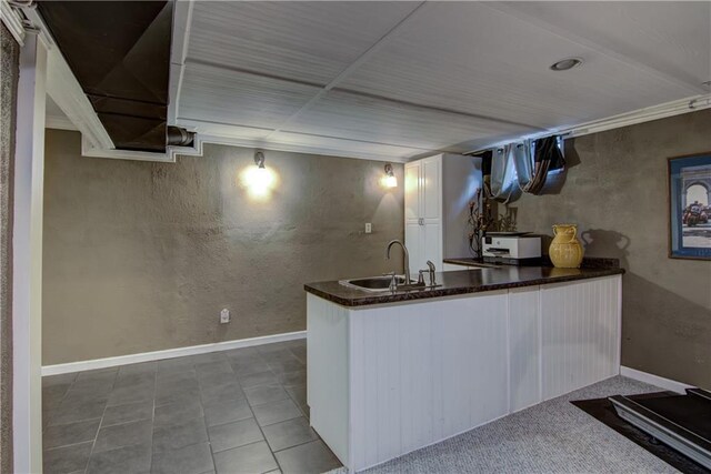 3736 Forest Knoll Dr, Eau Claire, WI 54701 - kitchen with white cabinetry, dark countertops, baseboards, and a sink