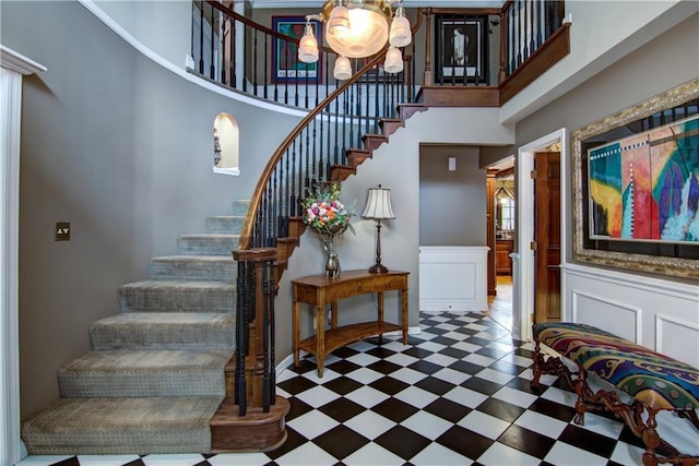 3736 Forest Knoll Dr, Eau Claire, WI 54701 - interior space featuring a decorative wall, tile patterned floors, a towering ceiling, and a notable chandelier