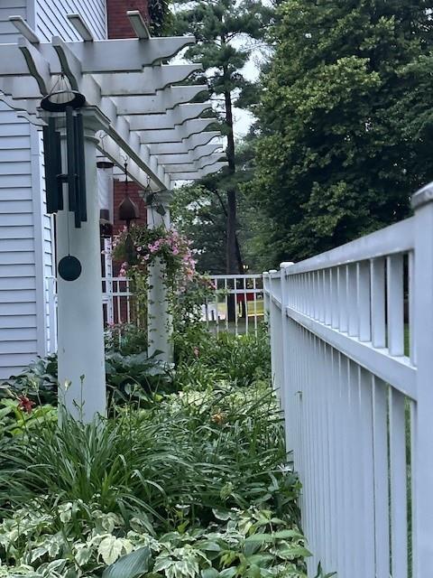 3736 Forest Knoll Dr, Eau Claire, WI 54701 - view of side of property featuring a pergola and fence