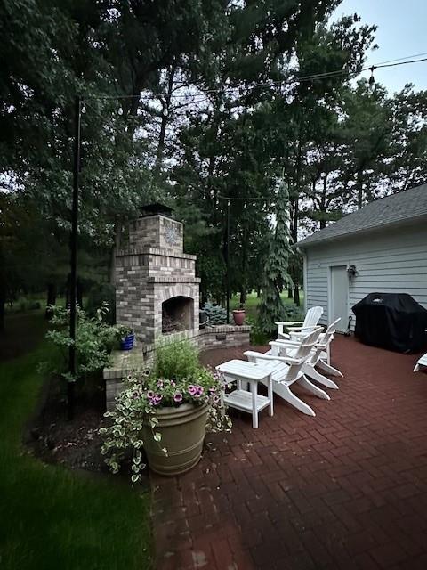 3736 Forest Knoll Dr, Eau Claire, WI 54701 - view of patio / terrace with an outdoor brick fireplace and area for grilling