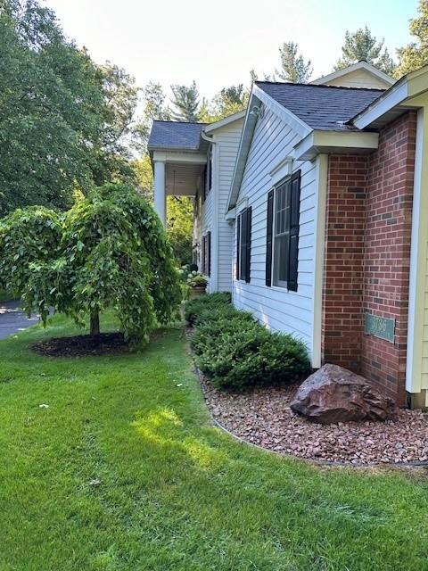 3736 Forest Knoll Dr, Eau Claire, WI 54701 - view of side of property with a lawn and brick siding