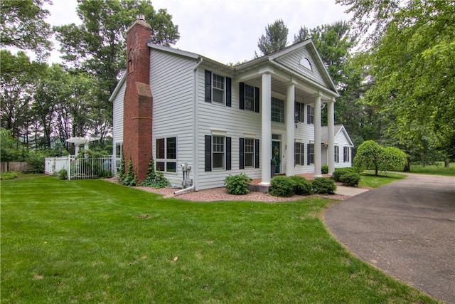 3736 Forest Knoll Dr, Eau Claire, WI 54701 - neoclassical home with a chimney and driveway
