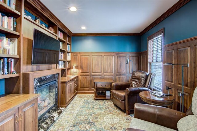 3736 Forest Knoll Dr, Eau Claire, WI 54701 - sitting room with a premium fireplace, recessed lighting, ornamental molding, built in features, and wainscoting