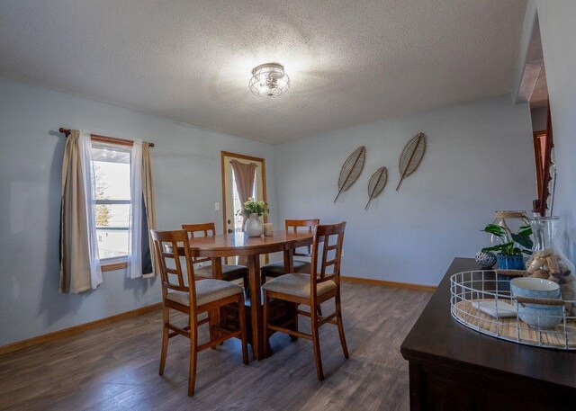 102 Highland St, Belmont, WI 53510 - dining room with dark wood-type flooring, a textured ceiling, and baseboards