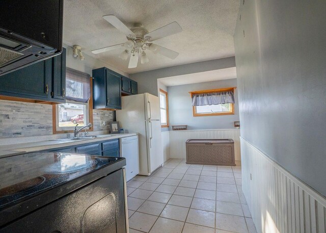 102 Highland St, Belmont, WI 53510 - kitchen featuring ceiling fan, light tile patterned floors, white appliances, a textured ceiling, and wainscoting