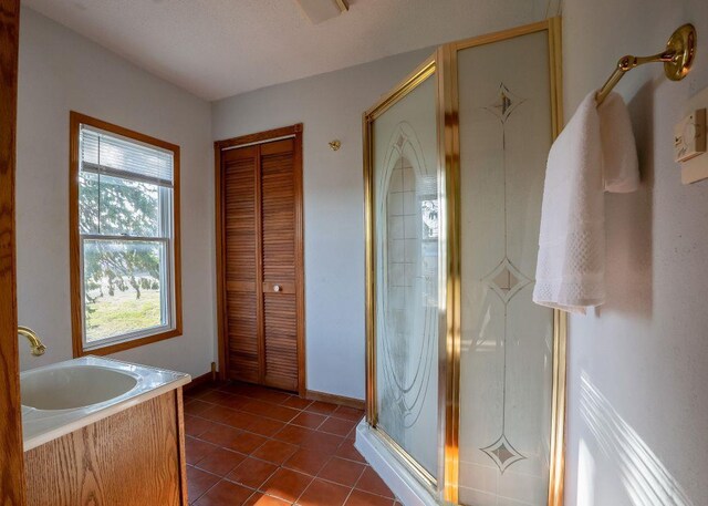 102 Highland St, Belmont, WI 53510 - full bath featuring a garden tub, a shower stall, a sink, tile patterned floors, and baseboards