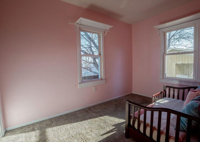 102 Highland St, Belmont, WI 53510 - carpeted bedroom featuring multiple windows and baseboards