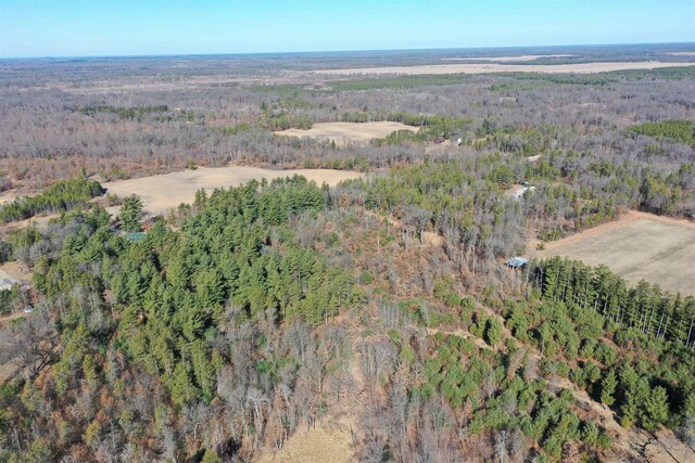 aerial view featuring a wooded view