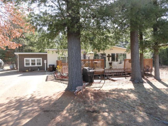 rear view of property with fence and a deck