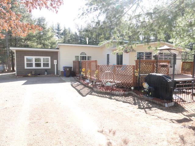 back of house featuring driveway and fence