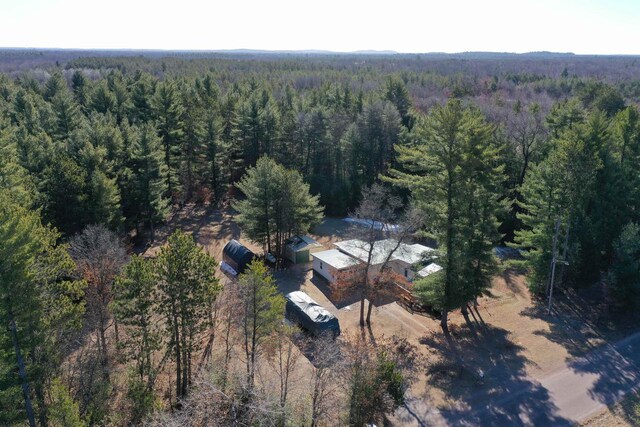drone / aerial view featuring a wooded view