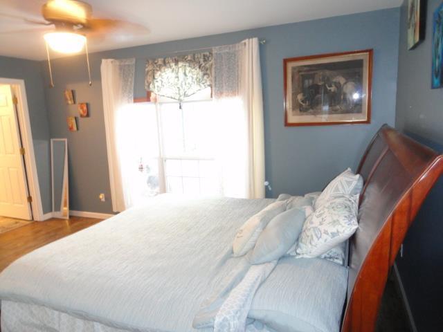 bedroom with baseboards and wood finished floors
