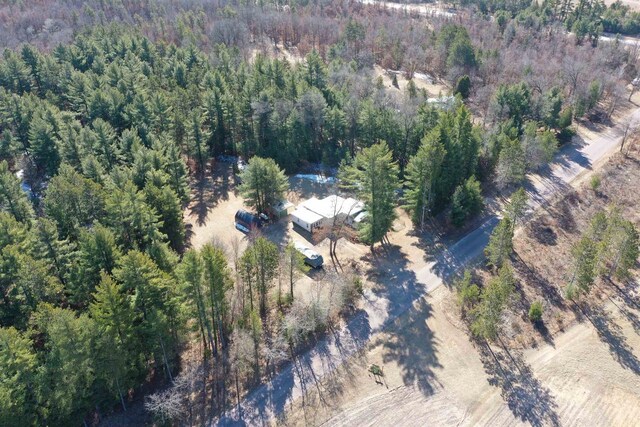 bird's eye view featuring a wooded view