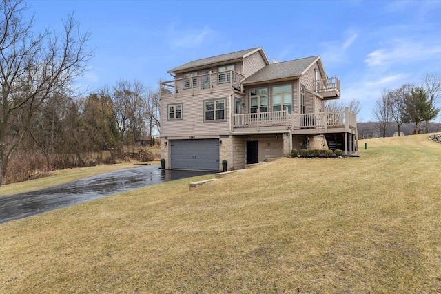 1646 N Friess Lake Dr, Hubertus, WI 53033 - view of front of home featuring a balcony, aphalt driveway, stone siding, an attached garage, and a front yard