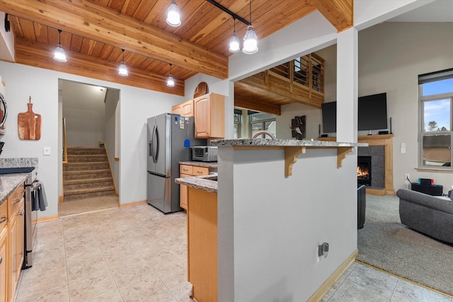 1646 N Friess Lake Dr, Hubertus, WI 53033 - kitchen with light stone countertops, stainless steel appliances, and beam ceiling