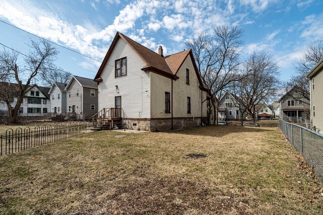 2214 N 40th St, Milwaukee, WI 53208 - view of property exterior with a fenced backyard, a chimney, a residential view, and a lawn